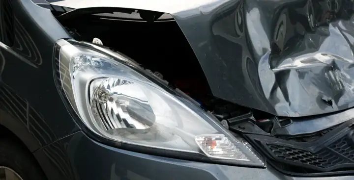 Front-end collision damage on a customer vehicle brought in to Lombard Auto Body for repair
