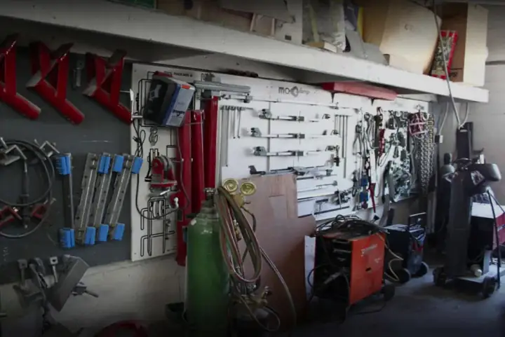 Frame-pulling rack, clamps, and welding equipment inside Lombard Auto Body's San Francisco shop