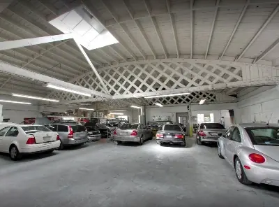 Inside Lombard Auto Body — multiple customer vehicles in the shop bays at 2340 Lombard Street, San Francisco